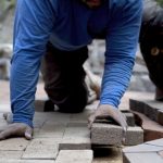 Closeup,Of,Hand,Putting,Brick,Paver,Into,Place,In,A